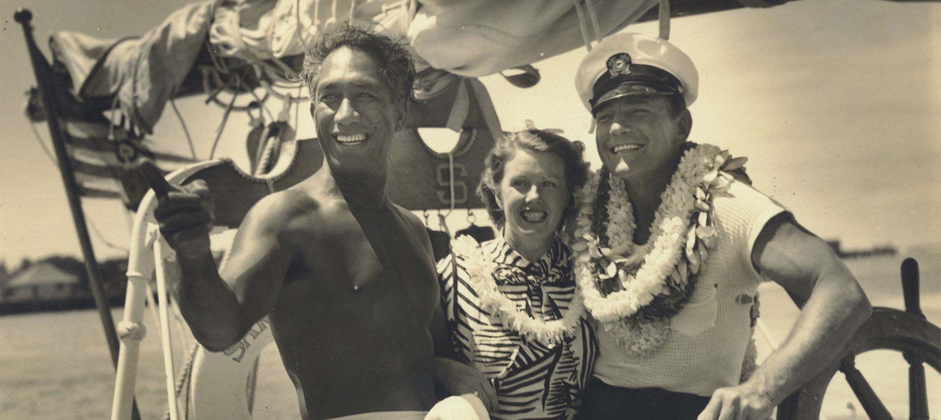 Duke on boat showing sailing couple something