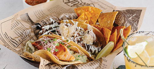 Fish tacos with chips and cocktail