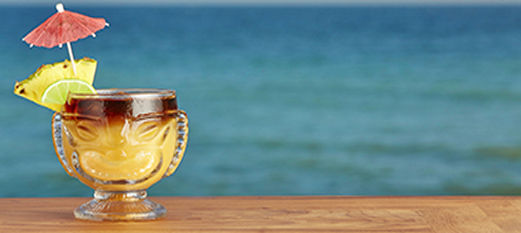 Tropical cocktail with beach in background