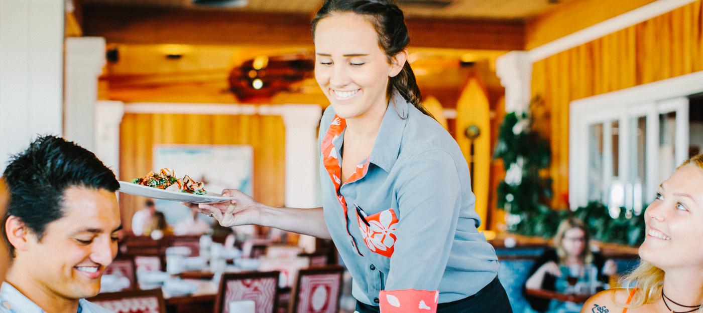 A waitress delivering a meal