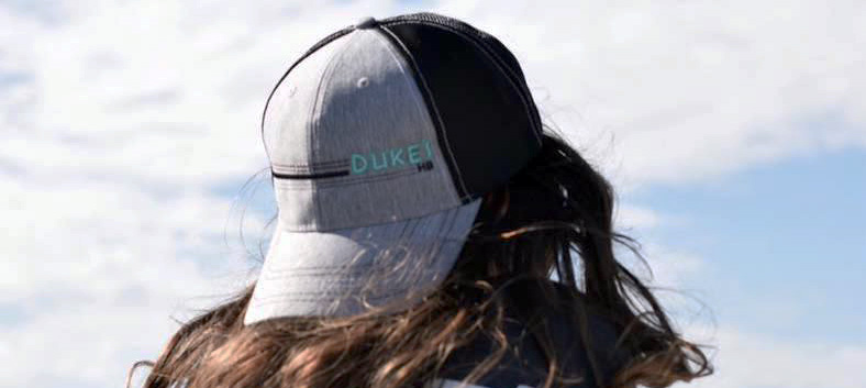 A girl wearing a Duke's HB hat